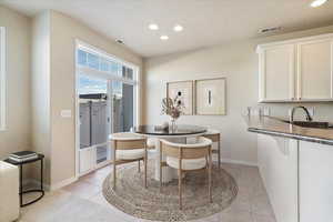 Dining space with visible vents, baseboards, light tile patterned flooring, recessed lighting, and a textured ceiling**Please note this is virtually staged**