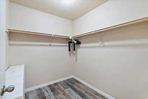 Walk in closet featuring dark wood-style floors