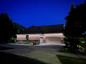 View of 3 car garage at twilight