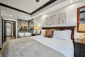 Bedroom featuring a tray ceiling, recessed lighting, and ornamental molding