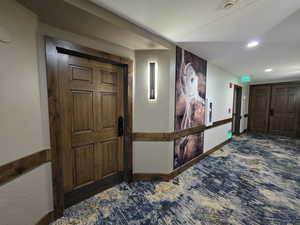 Corridor featuring recessed lighting, baseboards, and carpet