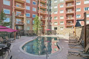 View of pool featuring a patio area and fence