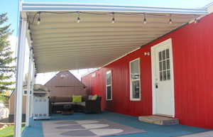View of patio / terrace featuring a carport and an outdoor living space