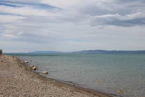 Property view of water with a mountain view and a beach view