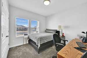 Bedroom with carpet flooring and baseboards