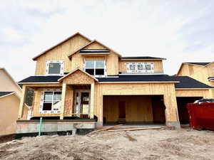 Property in mid-construction featuring an attached garage and central AC