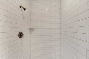 Main Floor Primary Bathroom with dual head tiled shower.