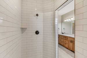 Main Floor Primary Bathroom with dual head tiled shower.