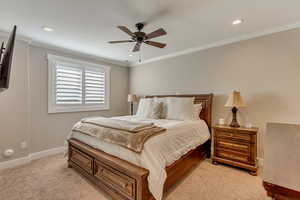 Downstairs In-law suite primary bedroom (5) with recessed lighting, light colored carpet, baseboards, and ornamental molding