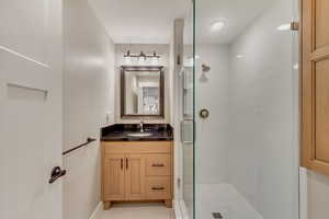 3/4 Bathroom in downstairs In-law suite featuring vanity and a shower stall