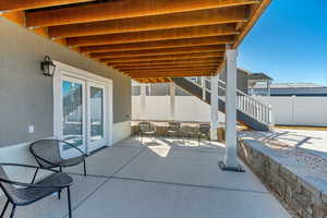 View of patio featuring outdoor seating area and downstairs In-law suite entrance.