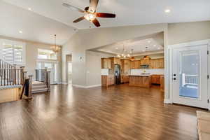 Unfurnished living room featuring wood floors, recessed lighting, stairs, and 5" baseboards.