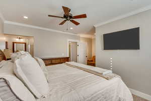 Downstairs In-law suite primary bedroom (5) with a ceiling fan, ensuite bath, recessed lighting, and crown molding