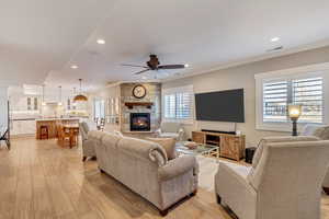 Downstairs In-law suite with plenty of natural light, light wood-style tile floors, and a ceiling fan.