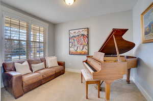 Living area with carpet and baseboards