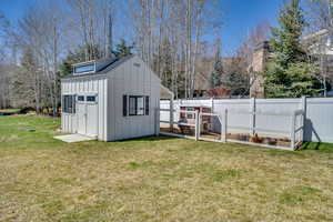 View of outbuilding featuring fence and an outdoor structure