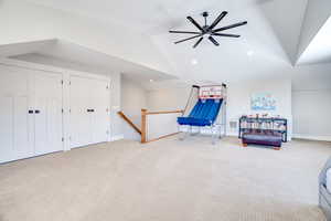 Living area featuring visible vents, lofted ceiling, an upstairs landing, carpet flooring, and recessed lighting