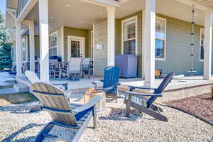 View of patio with covered porch and an outdoor fire pit