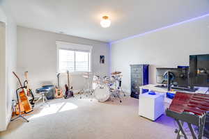 Carpeted home office with visible vents and baseboards