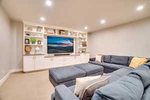 Living room with recessed lighting, light colored carpet, and baseboards