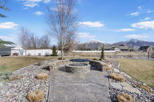 View of patio / terrace with a mountain view, a fire pit, and fence