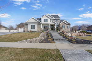 Craftsman house featuring driveway, a front lawn, board and batten siding, and an attached garage