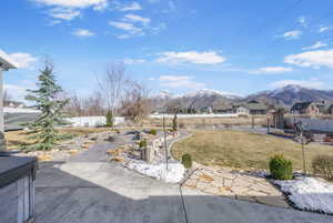 View of yard with a mountain view, a fenced backyard, and a patio