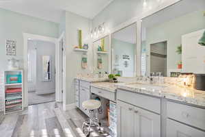 Master suite Full bath with vanity, baseboards, and wood finished floors