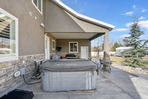 View of patio / terrace featuring a hot tub