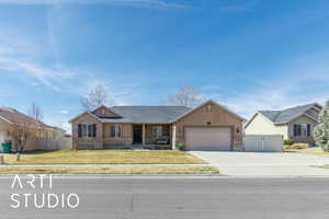 Ranch-style home featuring a front yard, a gate, fence, and an attached garage