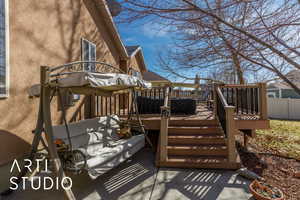 Wooden terrace featuring fence