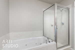 Full bathroom with a shower stall and a whirlpool tub