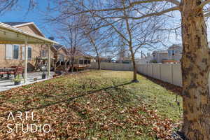 View of yard with a patio area, a residential view, a wooden deck, and a fenced backyard