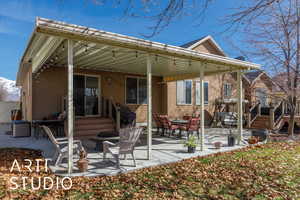 Rear view of house with a patio area and stucco siding