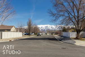 View of road featuring sidewalks, curbs, a mountain view, and a residential view