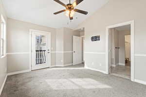 Unfurnished bedroom with carpet flooring, high vaulted ceiling, baseboards, and a ceiling fan