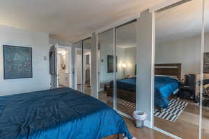 Bedroom featuring two closets and wood finished floors