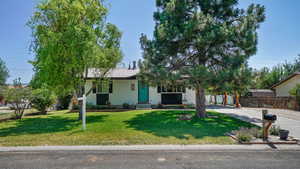 View of front of house featuring a metal roof, driveway, and entry steps