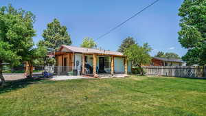 Rear view of house with a fenced backyard, a patio area, and a metal roof