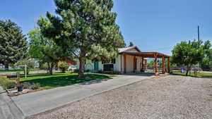 View of front facade featuring driveway and a carport