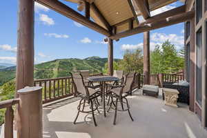 View of patio with a mountain view and outdoor dining area