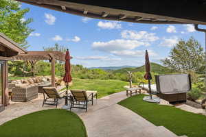 View of patio featuring an outdoor hangout area, a pergola, and a mountain view