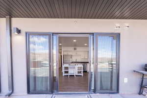 Property entrance featuring stucco siding and a sink