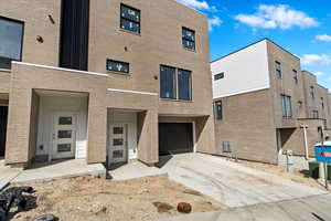 Exterior space featuring an attached garage and concrete driveway