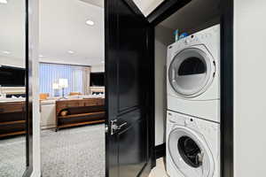 Washroom featuring laundry area, recessed lighting, and stacked washer / drying machine