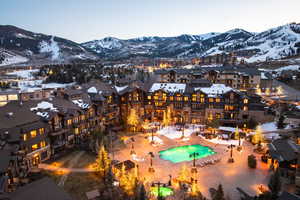 Snowy aerial view with a mountain view and a residential view