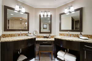 Full bathroom featuring tile patterned floors, decorative backsplash, a stall shower, and vanity