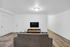 Living room with baseboards and light wood finished floors