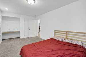 Bedroom featuring carpet flooring and baseboards