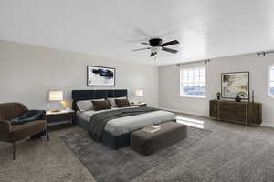 Carpeted bedroom with ceiling fan and baseboards